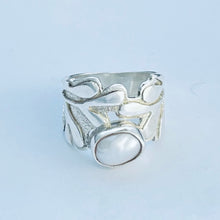 Load image into Gallery viewer, Silver ring with a large central stone on a light blue background