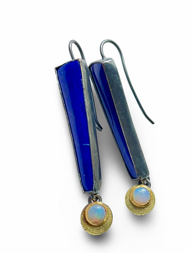 Pair of earrings with blue and gold components on a white background