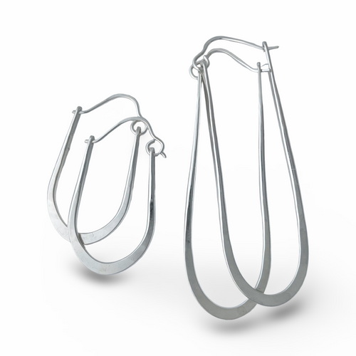 Pair of silver hoop earrings on a white background