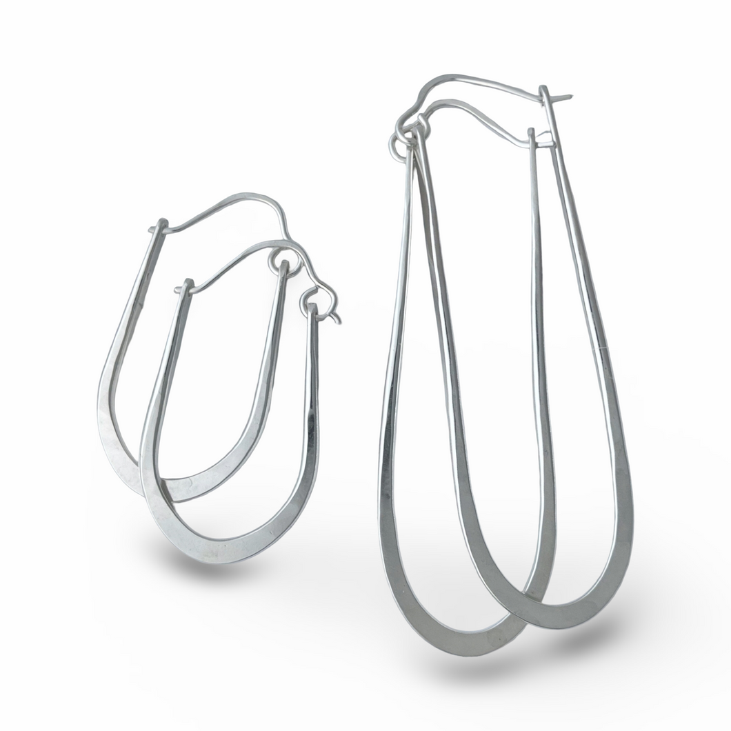 Pair of silver hoop earrings on a white background