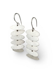 Load image into Gallery viewer, Pair of earrings with stacked white and silver disc designs on a white background
