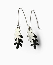 Load image into Gallery viewer, Pair of black and silver leaf-shaped earrings on a white background
