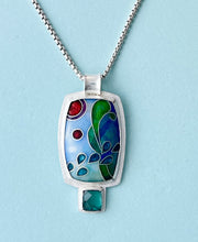 Load image into Gallery viewer, Colorful pendant necklace on a light blue background

