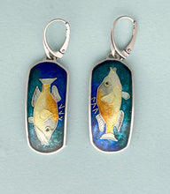 Load image into Gallery viewer, Pair of fish-shaped earrings with blue and gold design on a light blue background
