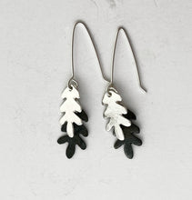 Load image into Gallery viewer, Pair of silver and black leaf-shaped earrings on a light gray background
