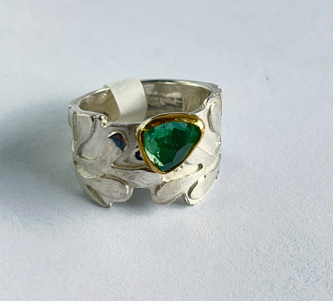 Green tourmaline set in 22k gold on silver ring
